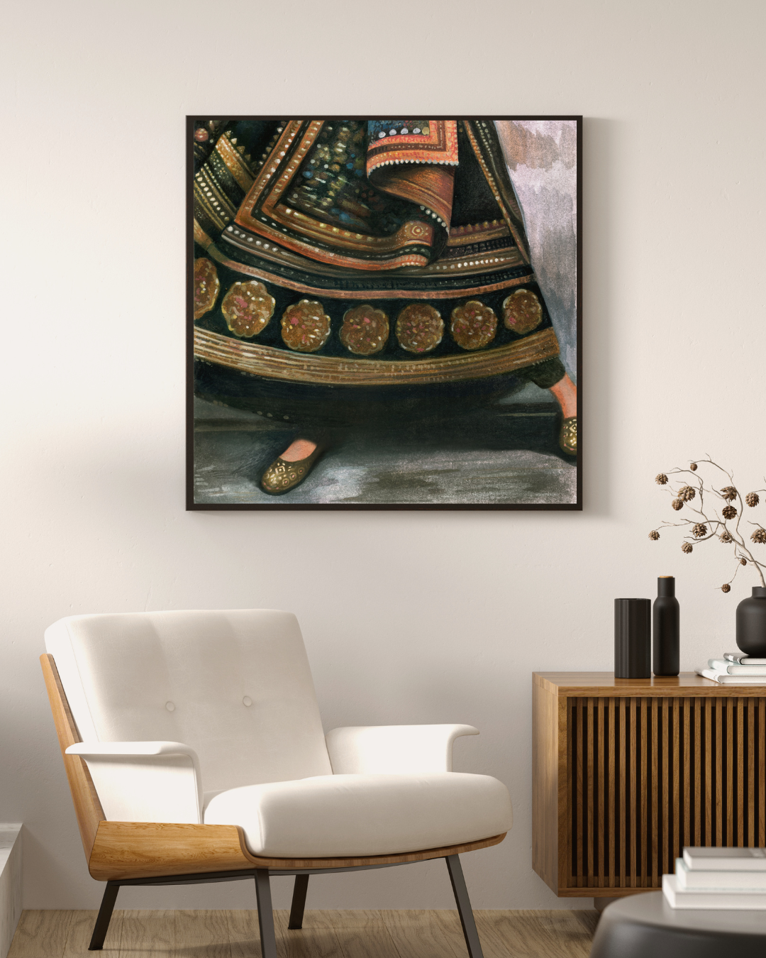 Framed artwork on a wall above a modern chair in a living room setting.